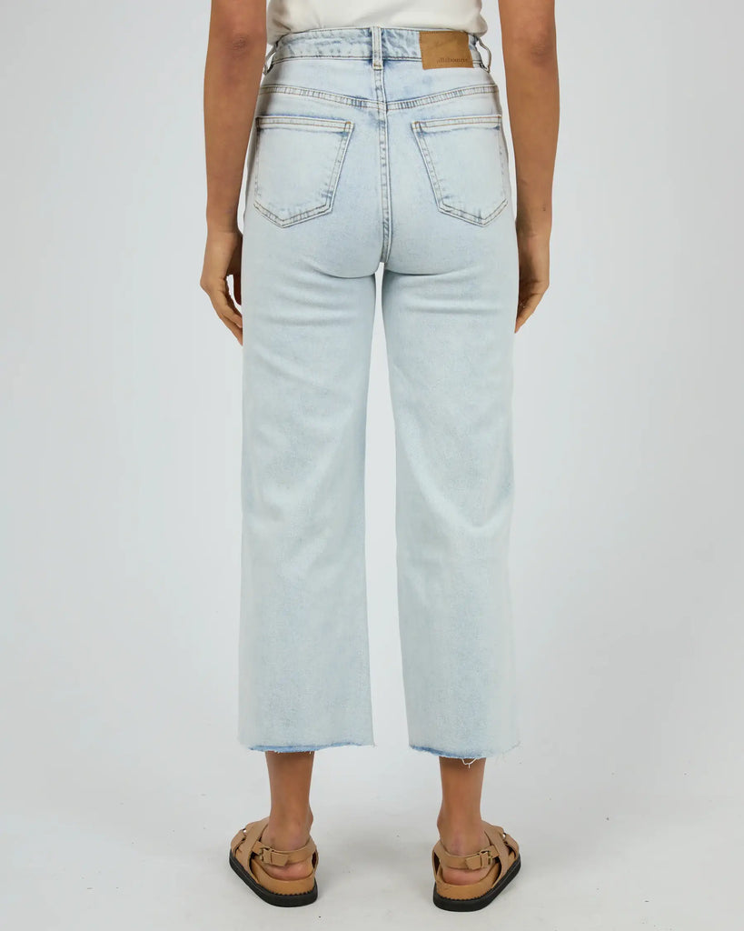 Light blue jeans worn by a person on a white background