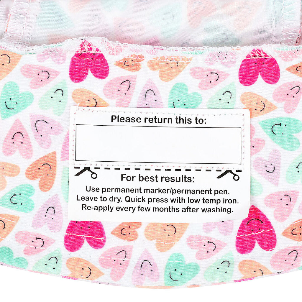 Fabric with smiley face pattern and care label on a white background