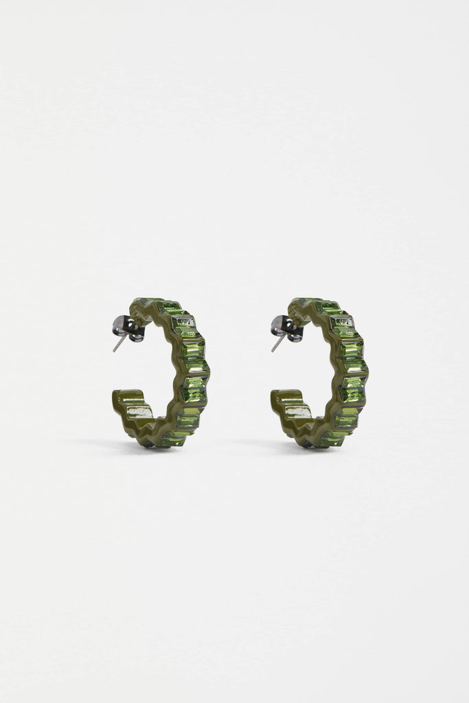Green hoop earrings on a white background