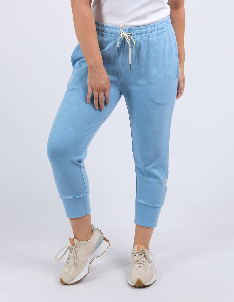 Light blue jogger pants worn by a person on a white background