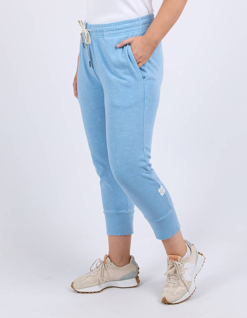 Light blue jogger pants worn by a person on a white background