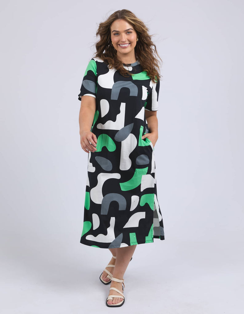 Woman wearing a patterned dress on a white background