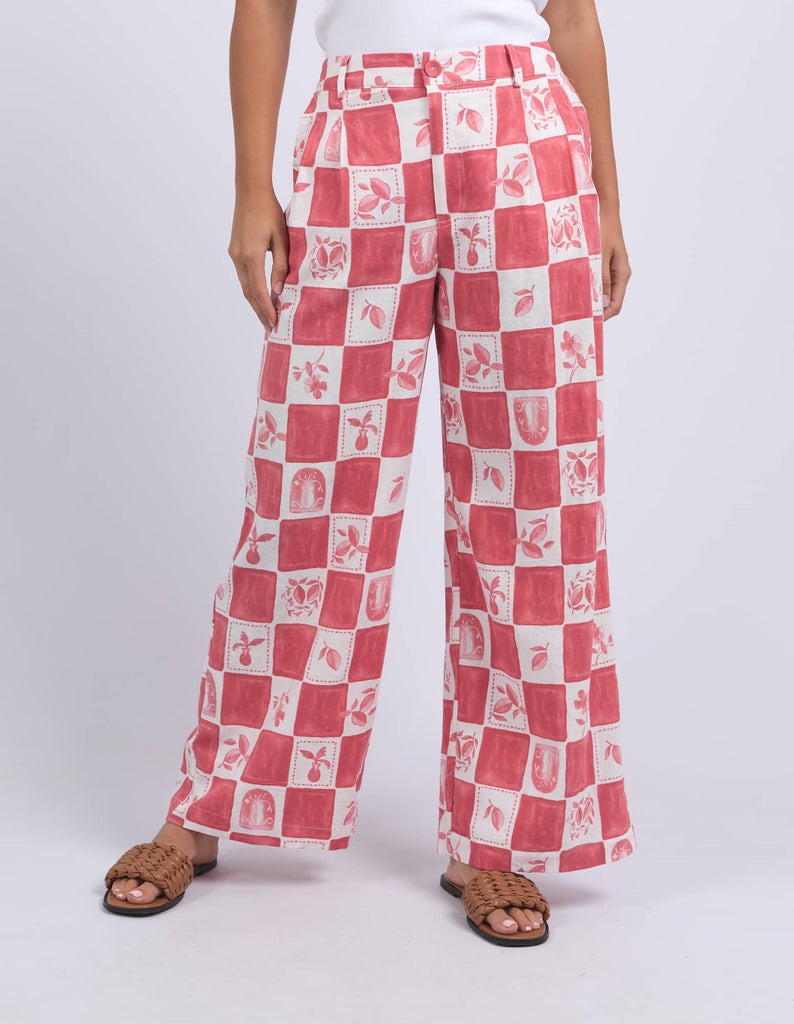 Red and white checkered pants worn by a person on a white background