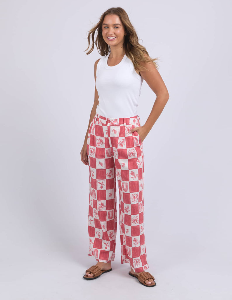 Woman wearing red and white checkered pants on a white background