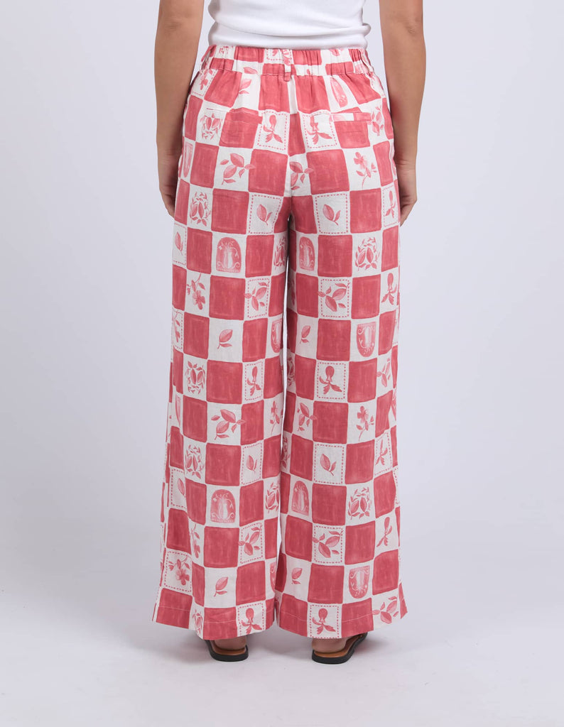 Red and white checkered pants worn by a person on a white background