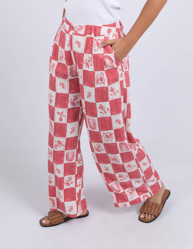 Red and white checkered pants worn by a person on a white background