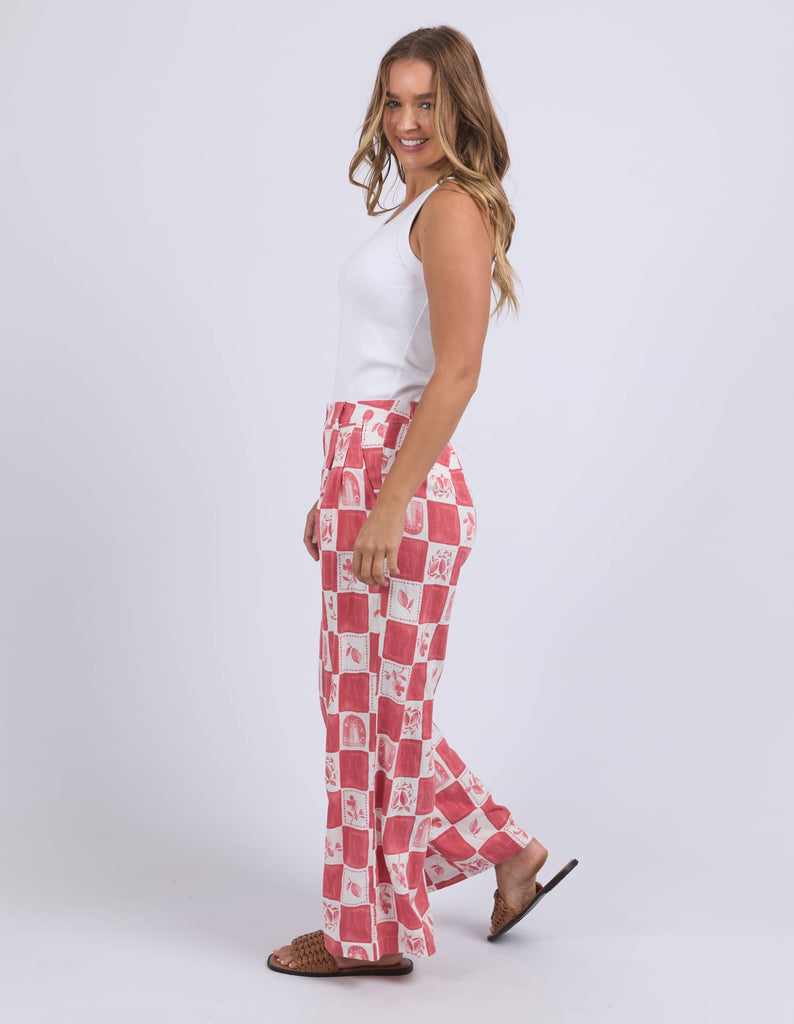 Woman wearing red and white checkered pants on a white background