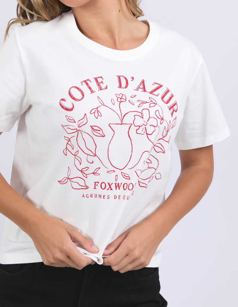 White t-shirt with red 'Cote d'Azur' design worn by a person on a white background