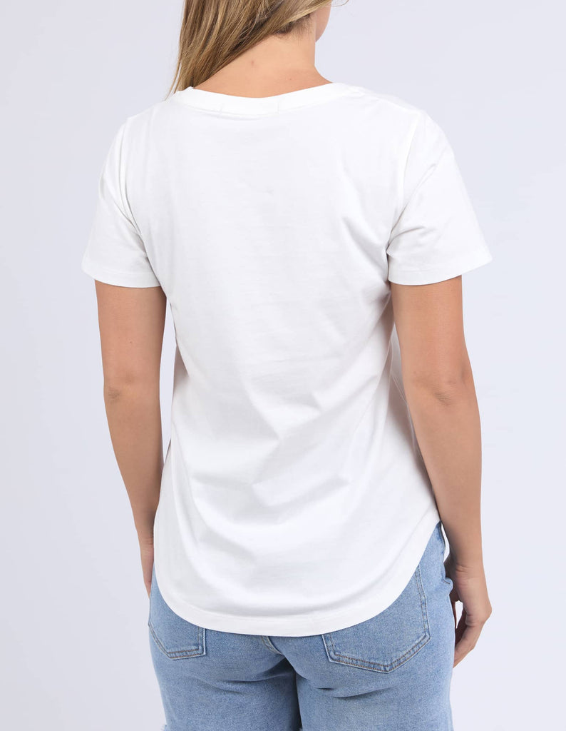 Person wearing a plain white t-shirt and light blue jeans on a light gray background