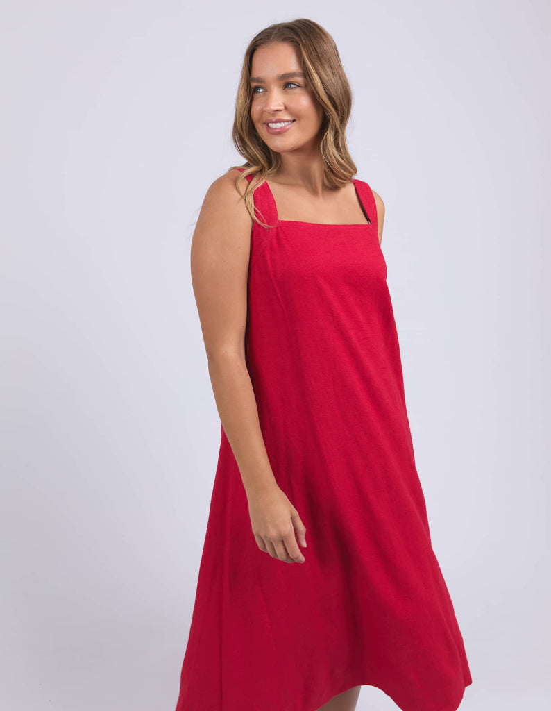 Woman wearing a red dress against a white background
