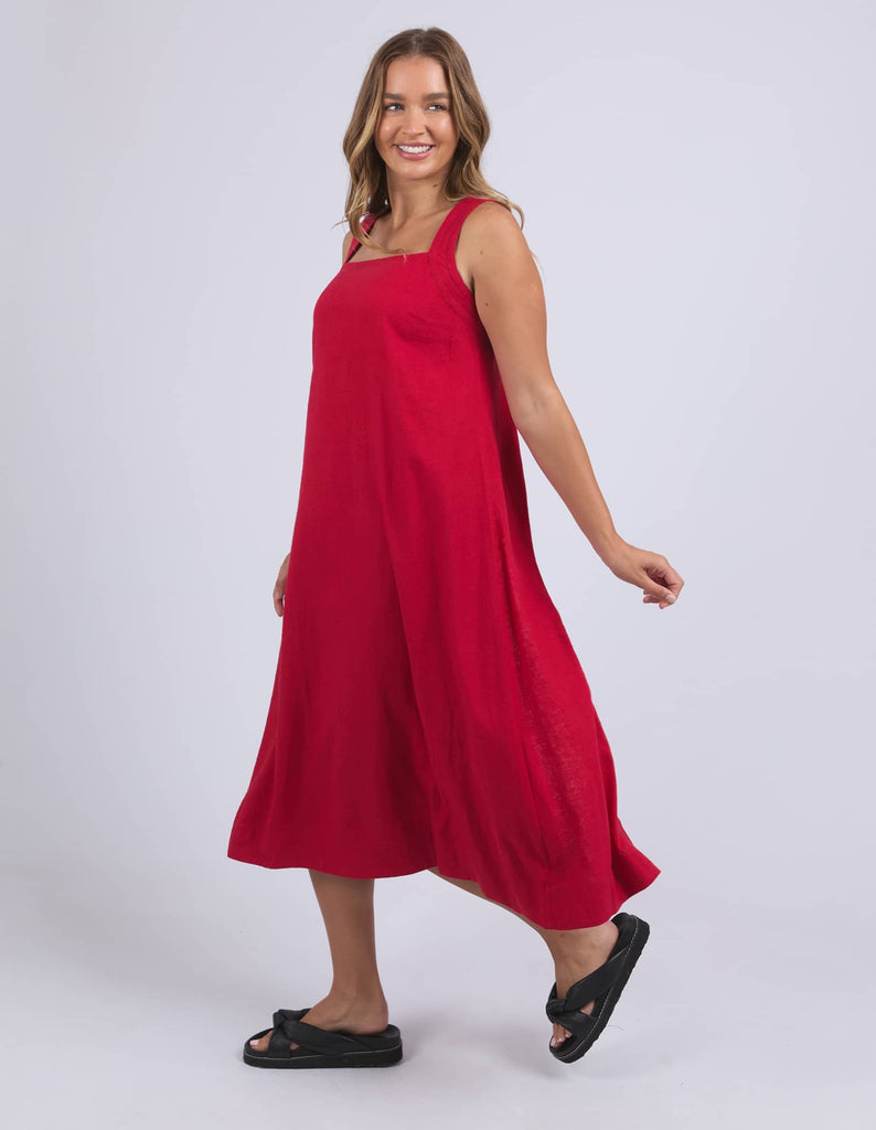 Woman wearing a red dress on a white background