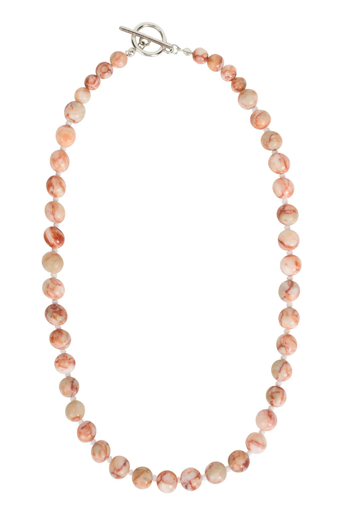Necklace with pink and beige beads on a white background