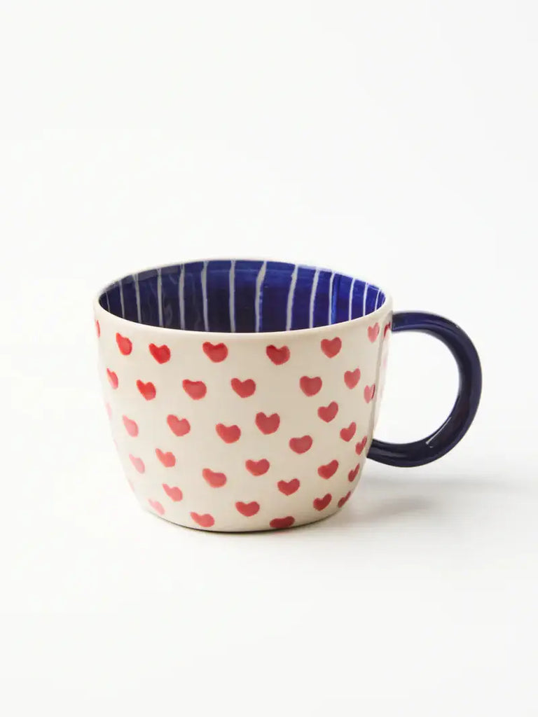 Mug with heart pattern and blue interior on a white background