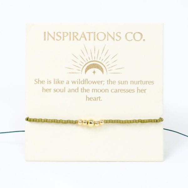 Gold bracelet on a card with 'Inspirations Co.' text and quote.