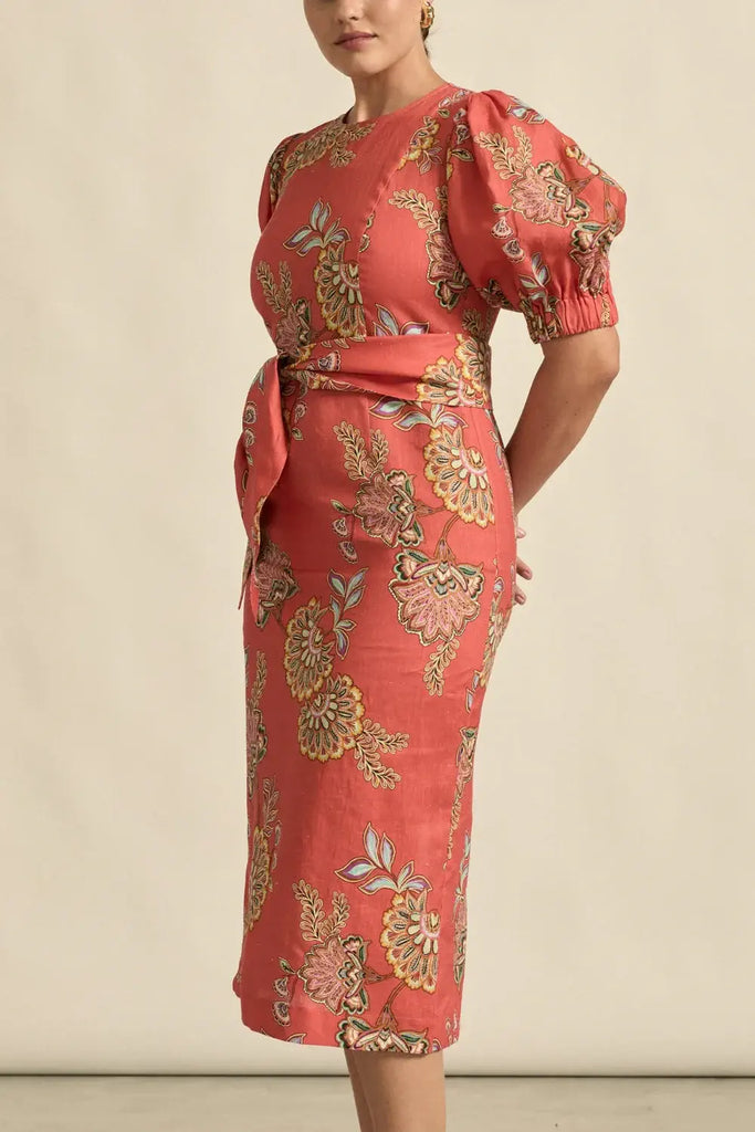 Red floral dress with puff sleeves on a beige background