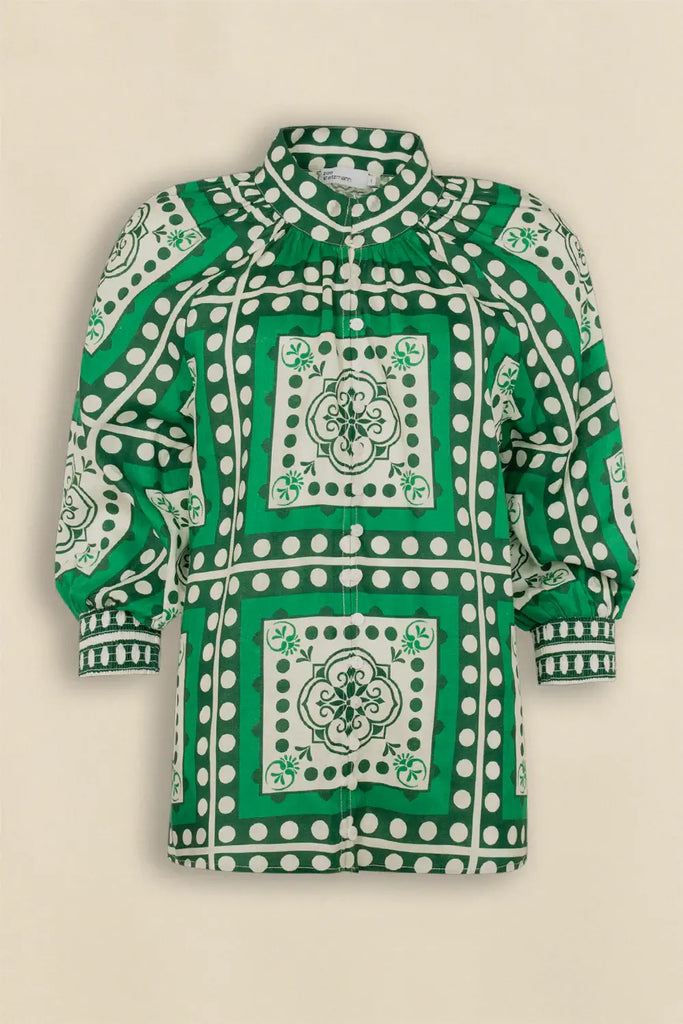 Green and white patterned shirt on a beige background