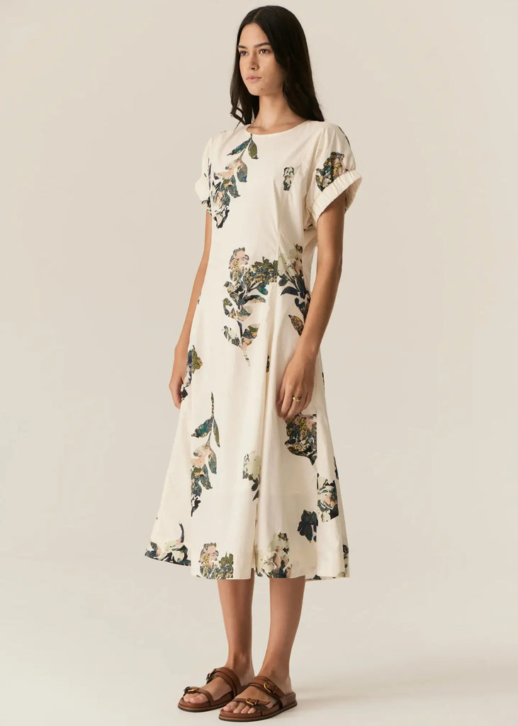 Woman wearing a floral dress on a plain background