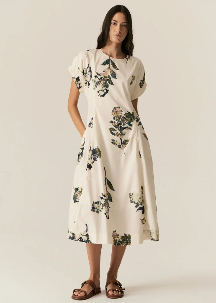 Woman wearing a floral dress on a plain background