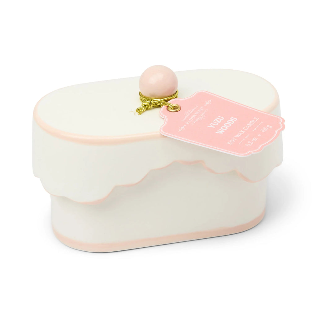 Decorative box with a pink top and gold accent on a white background