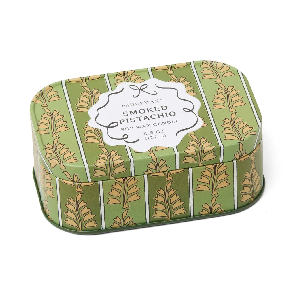 Green candle tin with leaf pattern and 'Smoked Pistachio' label on a white background
