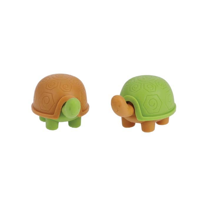 Two turtle-shaped objects, one brown and one green, on a white background.