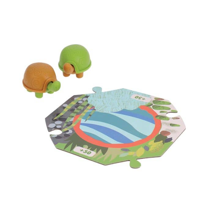 Two turtle figurines next to a hexagonal game board with a colorful design on a white background.