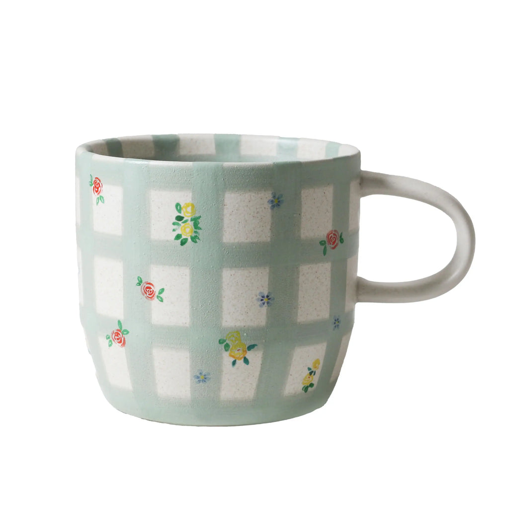 Mug with floral pattern on a light green checkered background