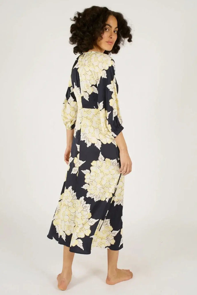 Woman wearing a black and white floral dress on a white background