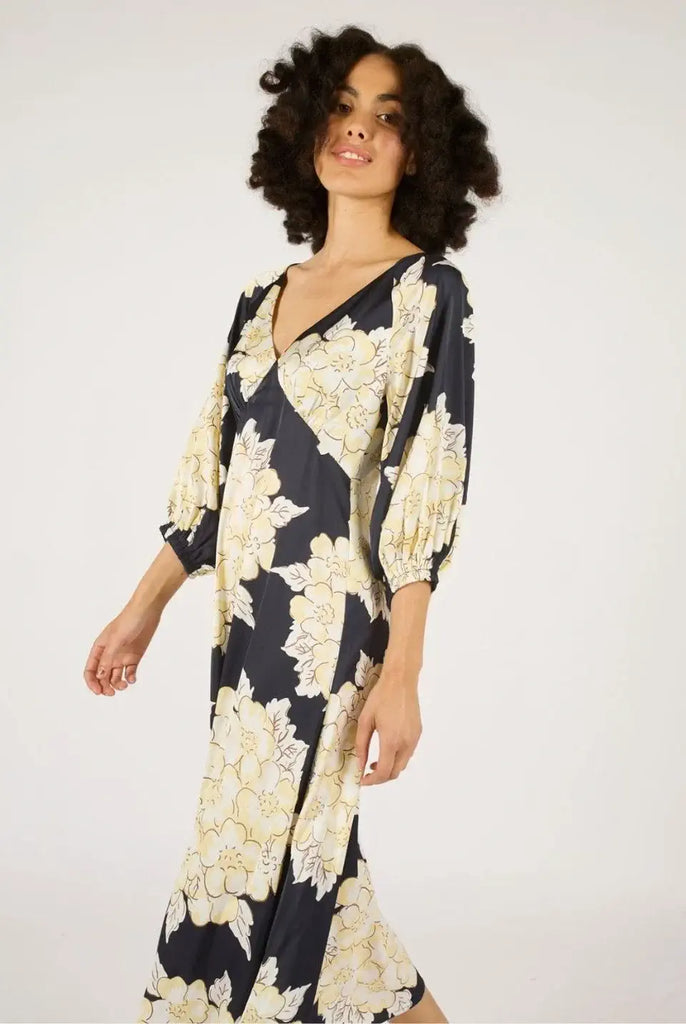 Woman wearing a floral dress with a plain background