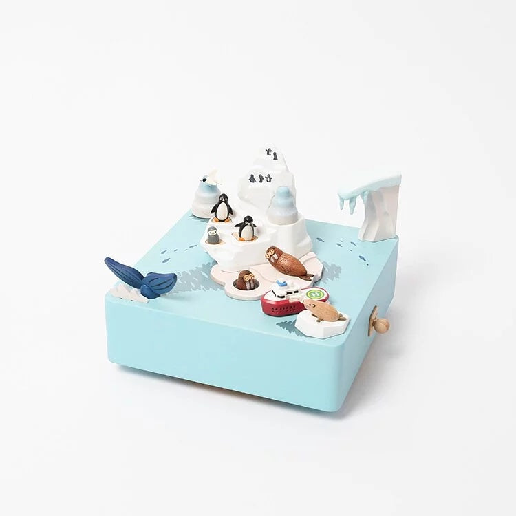 Toy set with penguins, seals, and a whale on a blue base with icebergs.