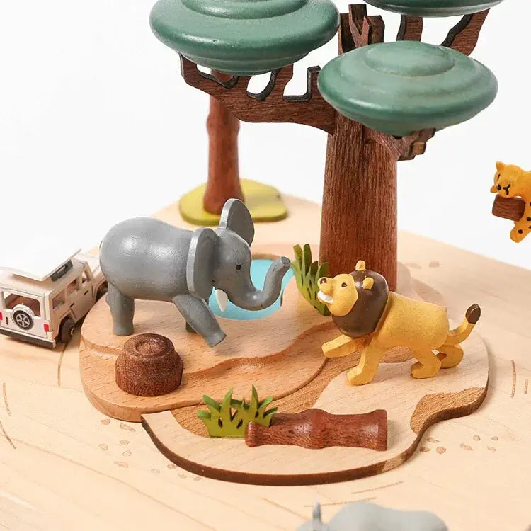 Toy animals and trees on a wooden base