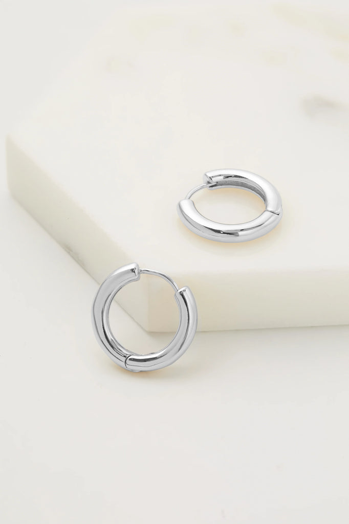 Pair of silver hoop earrings on a white background