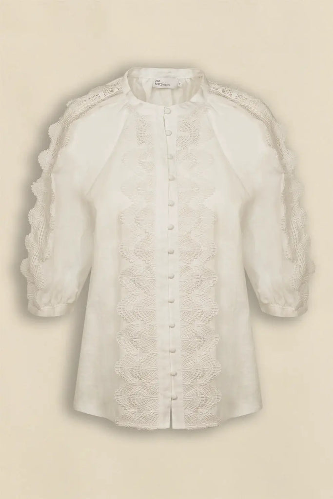 White lace blouse on a beige background