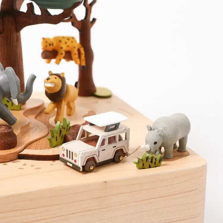 Toy safari scene with animals and a jeep on a wooden base