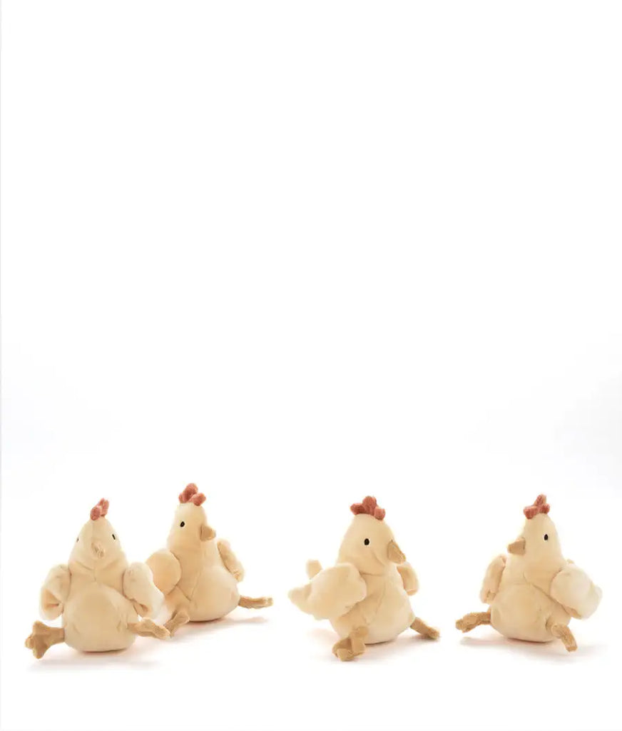 Four plush chicken toys on a white background