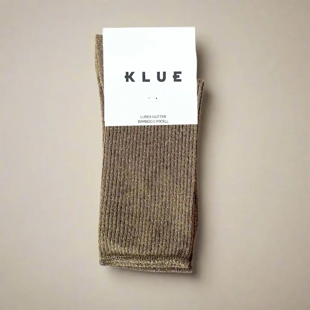 Brown sock with KLUE label on a beige background