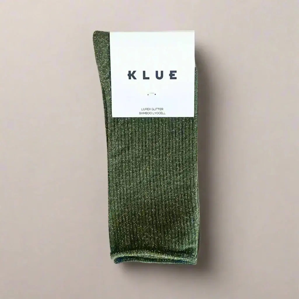 Green sock with KLUE label on a beige background