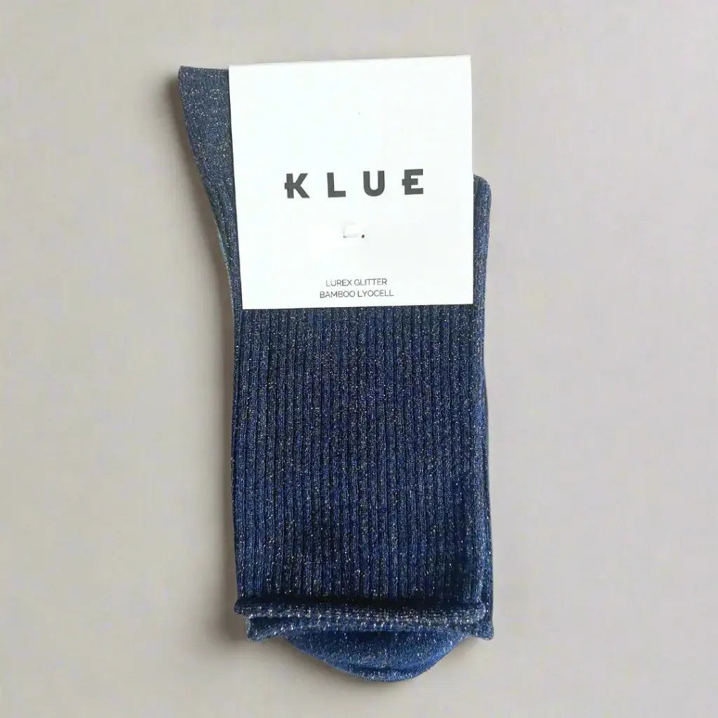 Blue sock with a KLUE label on a beige background