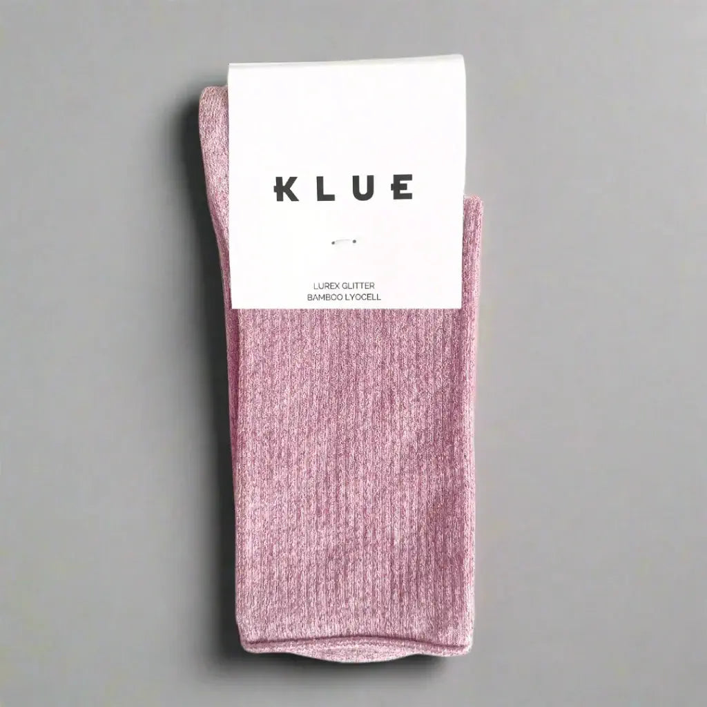 Pink sock with a white label on a gray background