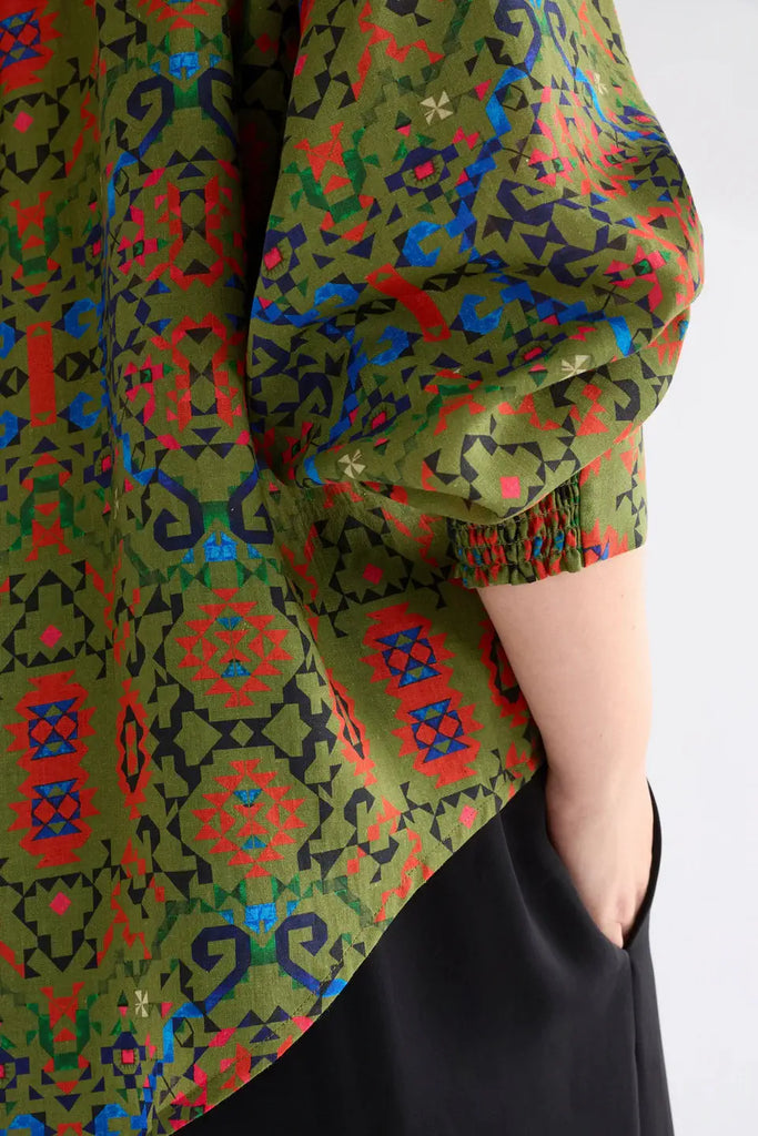 Person wearing a colorful patterned garment with a white background