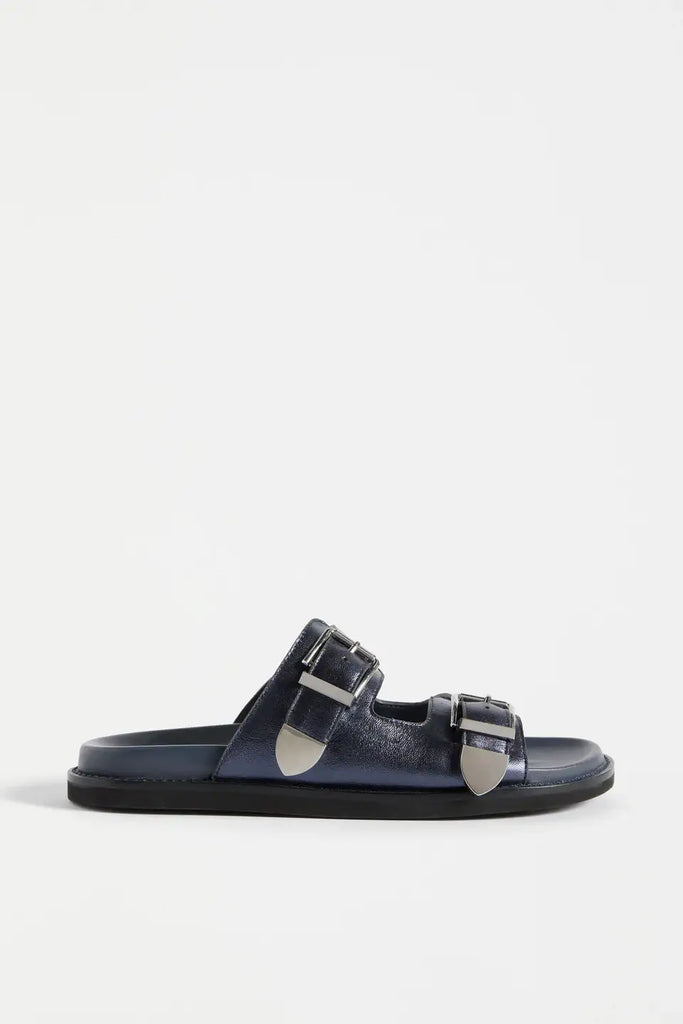 Black sandal with silver buckles on a white background