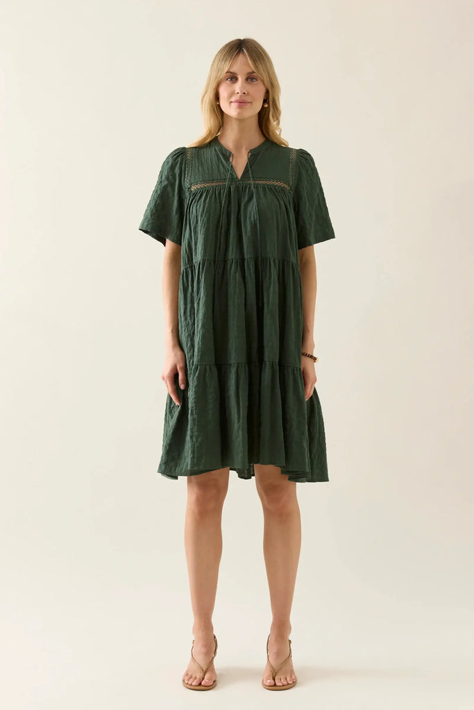 Woman wearing a green dress against a white background