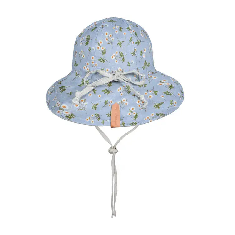 Floral patterned sun hat with a tie on a white background