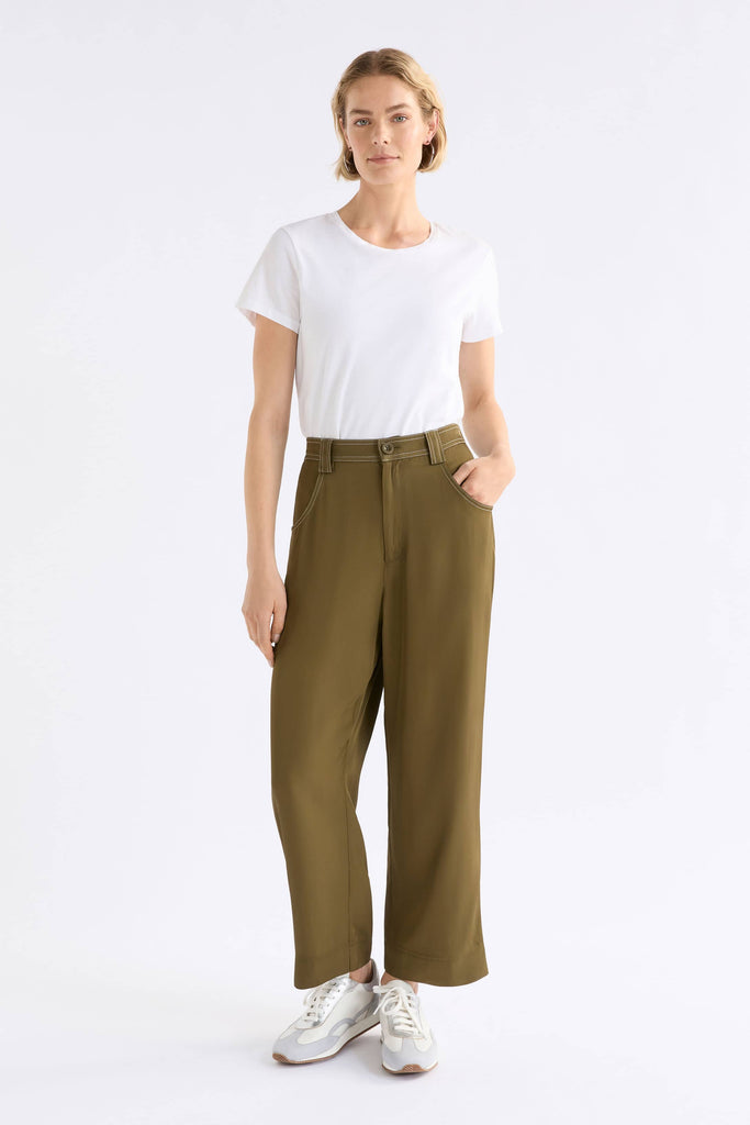Person wearing a white t-shirt and olive green pants on a white background